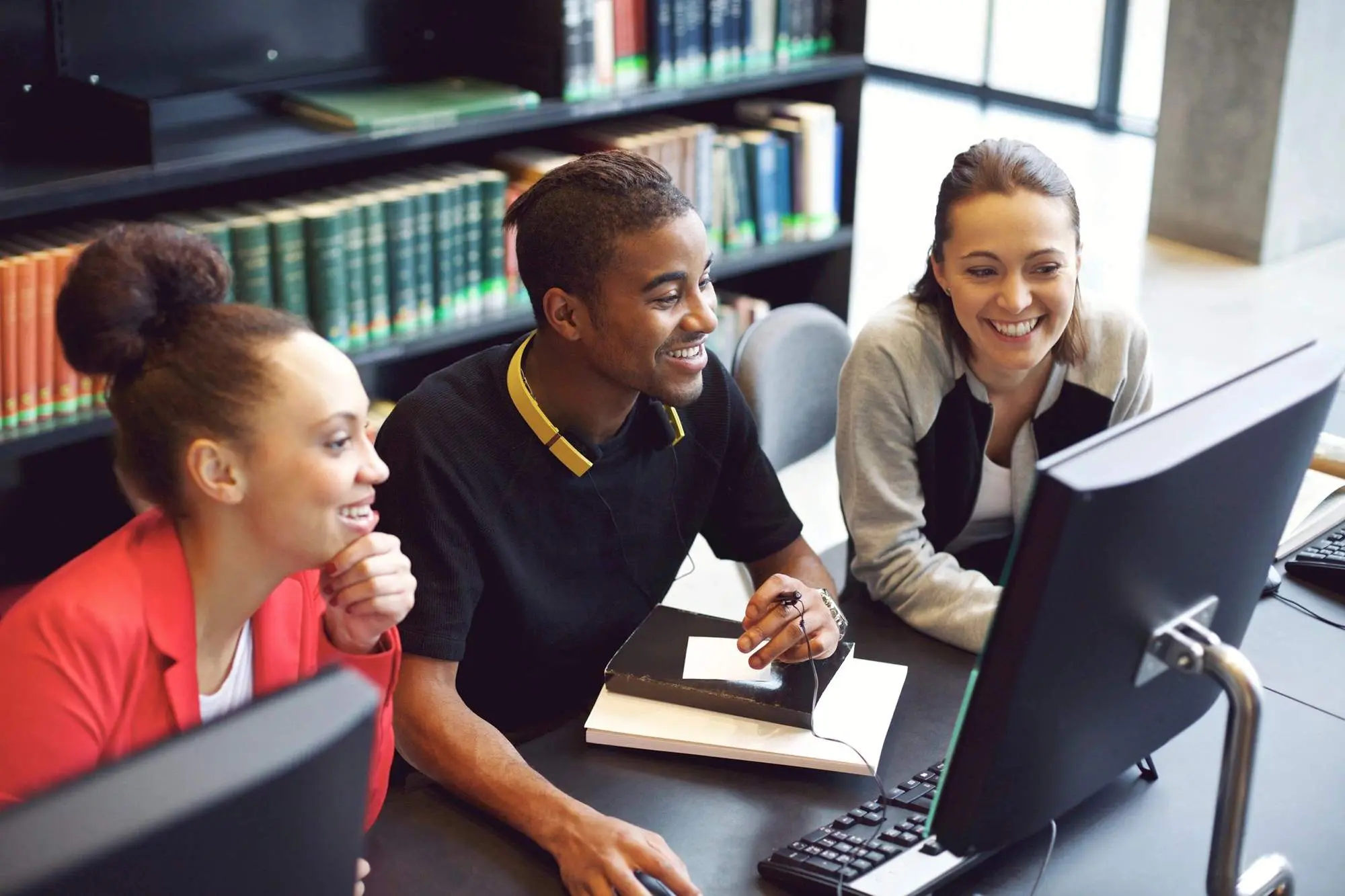 Three students working on the computer