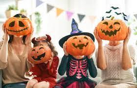 Four girls with Halloween pumpkin faces