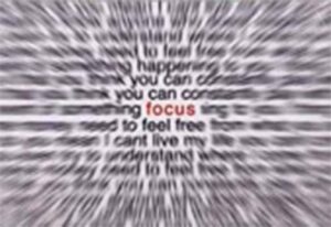 Blurred text with the word "focus" in clear view at the center, creating an optical illusion effect.